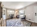 Bright and spacious living room with hardwood flooring and natural light, ideal for relaxing and entertaining at 1475 Lucille Ct, Northglenn, CO 80233