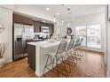 Modern kitchen with stainless steel appliances, a spacious island with seating, and sleek countertops at 5880 W 39Th Pl, Wheat Ridge, CO 80212