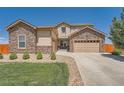 Charming two-story home with a stone and siding exterior and a well manicured lawn at 5923 S Jamestown Ct, Aurora, CO 80016