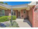 Inviting brick home entrance with colorful flowers and a seating area, creating a warm welcome at 2700 W Riverwalk Cir # C, Littleton, CO 80123
