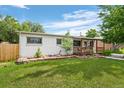 Exterior shot of a home highlighting the backyard and wooden porch at 8190 Raleigh Pl, Westminster, CO 80031