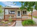Charming home with a covered porch, featuring a wood railing and decorative elements at 8190 Raleigh Pl, Westminster, CO 80031