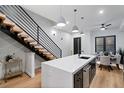 Stylish kitchen with floating staircase, a large island, stainless steel appliances, and modern pendant lighting at 2010 Pearl St # B, Boulder, CO 80302