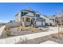 Attractive two-story home with stone accents, a welcoming porch, and manicured front landscaping at 4407 N Quemoy St, Aurora, CO 80019