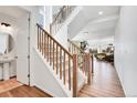 Welcoming foyer with hardwood floors, a staircase with wooden banister, and views into the living area at 4407 N Quemoy St, Aurora, CO 80019