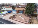 Wide shot of a single-story home featuring a landscaped front yard, two-car garage and flag at 11397 Kendall St, Westminster, CO 80020