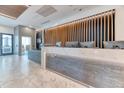 Modern condo lobby with a reception desk, decorative lighting, and sleek finishes at 891 14Th St # 2002, Denver, CO 80202