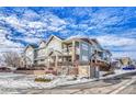 Townhouse Exterior: Two-story building with balconies and a gated entrance at 9451 Ashbury Cir # 202, Parker, CO 80134