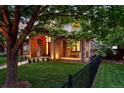 Charming stone and stucco home with a cozy front porch and lush, landscaped yard at 1351 S Milwaukee St, Denver, CO 80210