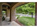 A stone-paved porch with arches showcases the manicured front yard and landscaping at 1351 S Milwaukee St, Denver, CO 80210