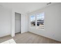 Bright bedroom featuring carpeted floors, two large windows, and closet with sliding door at 1281 Rock Cliff Ave, Erie, CO 80516