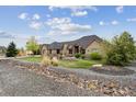 Beautiful home with lush landscaping, stone accents, and a well-maintained lawn at 12939 Wabash Ct, Thornton, CO 80602