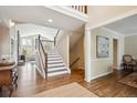 Bright foyer features hardwood floors, staircase, and entry to the living area at 5320 S Geneva St, Englewood, CO 80111