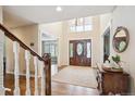 Elegant foyer with hardwood floors, wooden door, and high ceilings with clerestory windows at 5320 S Geneva St, Englewood, CO 80111