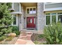 Charming home featuring a brick entryway and a vibrant red front door at 5320 S Geneva St, Englewood, CO 80111