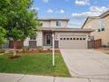 Charming two-story home boasts a well-manicured lawn, neutral siding, and an attached two-car garage at 15350 W 50Th Dr, Golden, CO 80403