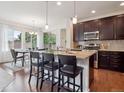 Open kitchen with granite countertops, a center island, and a connected dining area at 15350 W 50Th Dr, Golden, CO 80403