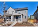 Two-story townhome featuring modern siding, a cozy porch, and drought-resistant landscaping at 11119 E 25Th Dr, Aurora, CO 80010
