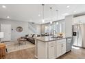 Open-concept kitchen with granite countertops, stainless steel appliances, and hardwood floors at 11119 E 25Th Dr, Aurora, CO 80010