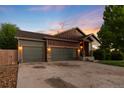 Home exterior showcasing a three-car garage, well-maintained lawn, and inviting front entrance at 2746 Stallion Way, Mead, CO 80542
