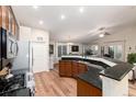 Spacious kitchen with stainless steel appliances, dark countertops, and hardwood floors at 2746 Stallion Way, Mead, CO 80542