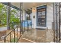 Inviting front porch with wrought iron details and cozy seating at 4001 Kalamath St, Denver, CO 80211