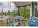 Front porch with ornate railing, seating, and vibrant plants creating a welcoming entrance at 4001 Kalamath St, Denver, CO 80211