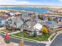 Stunning aerial view of a lakeside community with mature trees and colorful homes with solar panels at 6276 S Robertsdale Ct, Aurora, CO 80016