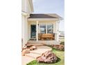 Inviting front porch with swing bench, stone accents, and landscaped entryway at 9665 Bighorn Way, Littleton, CO 80125