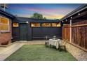 Private backyard features a small turf area, decorative gravel, string lights, and a dining set for outdoor enjoyment at 2731 W 42Nd Ave, Denver, CO 80211