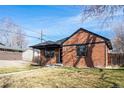Charming brick home showcasing a well-maintained lawn and inviting architectural details at 2731 W 42Nd Ave, Denver, CO 80211