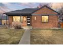 Inviting brick home with a well-lit entrance and a tidy front lawn at 2731 W 42Nd Ave, Denver, CO 80211