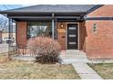 Close-up of brick home entrance with modern door and visible house number at 2731 W 42Nd Ave, Denver, CO 80211