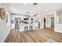 Bright, open kitchen with white cabinets, stainless steel appliances, and a large island at 2731 W 42Nd Ave, Denver, CO 80211