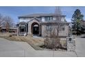 Charming two-story home with a brick facade, arched entryway, and well-kept landscaping at 5284 Taft Ct, Arvada, CO 80002