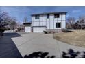 Spacious three-car garage with driveway, offering ample parking and storage for vehicles and outdoor equipment at 5284 Taft Ct, Arvada, CO 80002