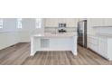 Open kitchen with a center island, stainless steel appliances, and modern finishes at 7213 Waterleaf Trl, Littleton, CO 80125
