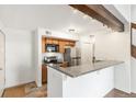 Kitchen features wood cabinets, stainless steel appliances, granite countertops and bar top seating at 2575 S Syracuse Way # M307, Denver, CO 80231