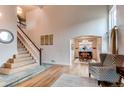 Bright foyer featuring a staircase with wood and tile accents, leading to a dining area with natural light at 6647 Lynx Cv, Lone Tree, CO 80124