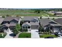 Aerial view of a well maintained house with a lawn in a neighborhood near fields and a walking path at 6193 Saddle Bow Ave, Parker, CO 80134