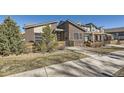 Contemporary home showcasing a brick facade, modern design, and inviting outdoor space at 12441 W Virginia Ave, Lakewood, CO 80228