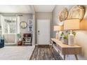 Charming entryway with modern decor, stylish console table, and plenty of natural light at 23469 E Briarwood Pl, Aurora, CO 80016