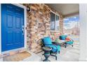 Inviting front porch with comfortable seating and brick detailing, perfect for relaxing outdoors at 23469 E Briarwood Pl, Aurora, CO 80016