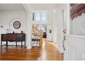 Open entryway with hardwood floors, high ceilings, and staircase leading to upper level with lots of natural light at 16665 Kenuil St, Brighton, CO 80603