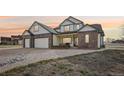 Charming two-story home with a brick accent, a spacious three-car garage, and a beautifully landscaped front yard at 16665 Kenuil St, Brighton, CO 80603