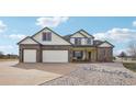 Charming two-story home with a brick accent, a spacious three-car garage, and a beautifully landscaped front yard at 16665 Kenuil St, Brighton, CO 80603