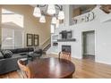 Bright and airy living room featuring hardwood floors, high ceilings, and a cozy fireplace at 10212 Kelliwood Way, Highlands Ranch, CO 80126