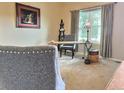 Cozy home office featuring a work desk by a window, a gray chair, and decorative ladder at 13313 Elizabeth St, Thornton, CO 80241
