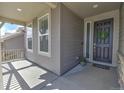 Inviting front porch with a dark-colored front door adorned with a decorative wreath at 7167 Hyland Hills St, Castle Pines, CO 80108