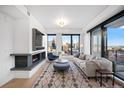 Stylish living room features a modern fireplace, large windows, and hardwood flooring at 1750 Wewatta St # 1720, Denver, CO 80202